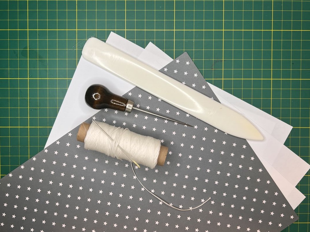 Some bookbinding tools laid out ready to use