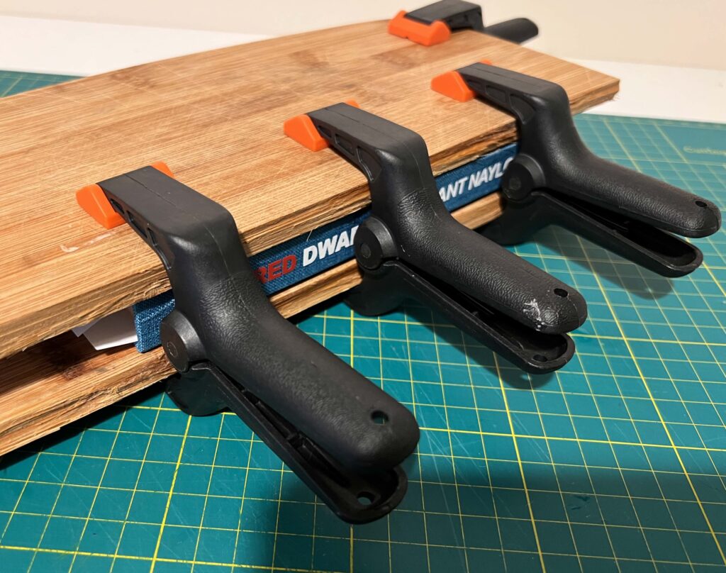 Some clamps holding the newly bound book in place