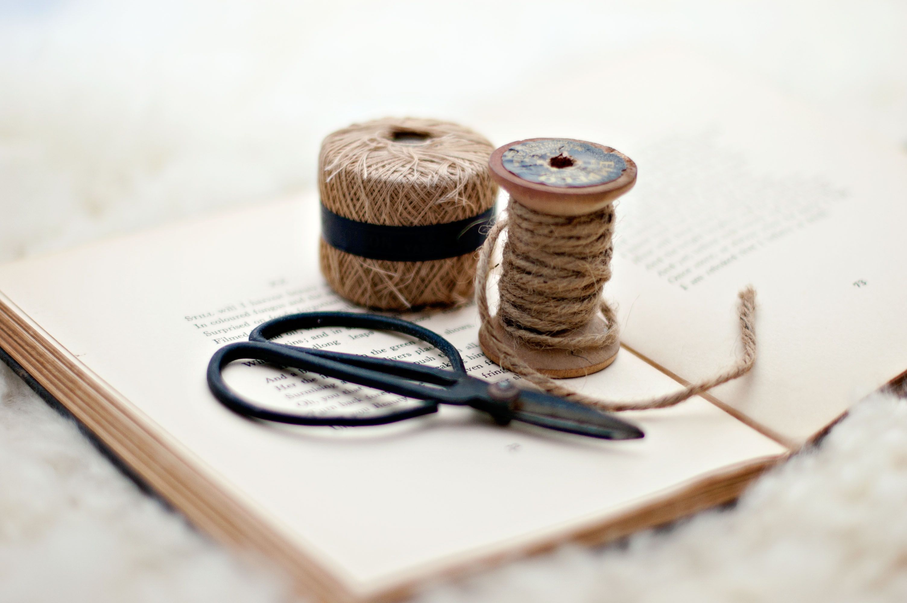 An image of an open book with book binding tools upon it